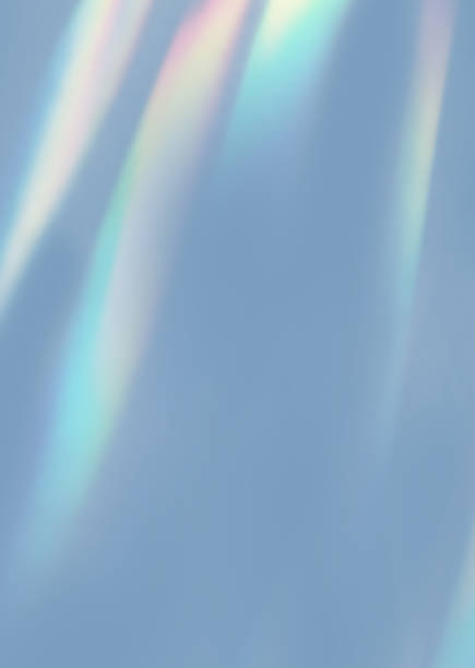 istock Blurred rainbow light refraction texture overlay effect for photo and mockups. Organic drop diagonal holographic flare on a white wall. Shadows for natural light effects 2153644314
