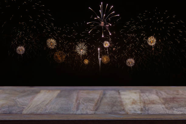 Empty wooden table top with fireworks background symbolizes celebration and happiness. For product presentation simulation