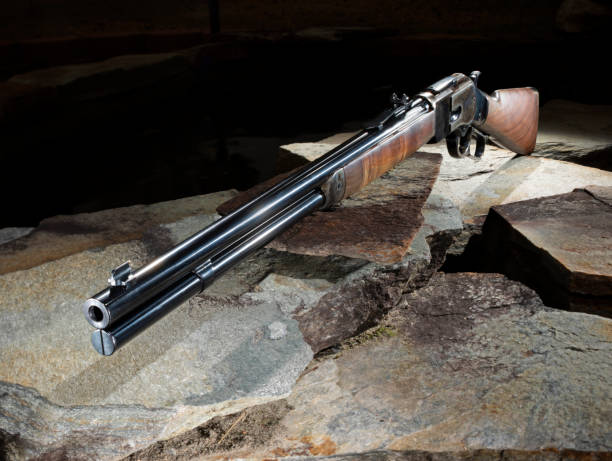 istock Wood stocked lever action rifle with a dark background 2153647155