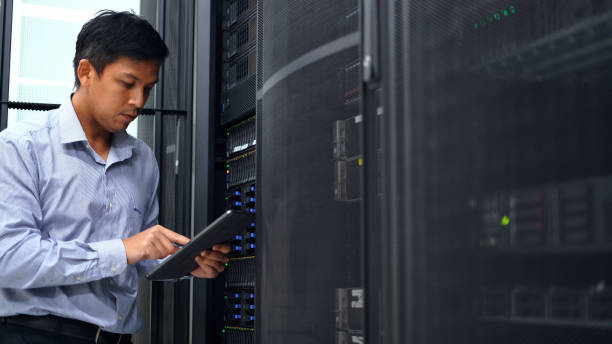 istock System administrator working with digital tablet to check server and equipment  in data center. 2153648135