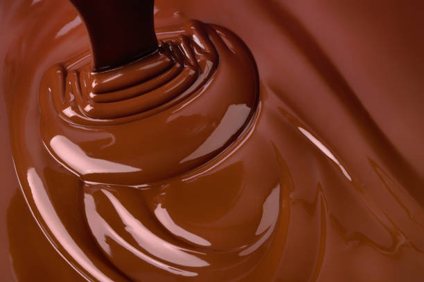 istock stream melt chocolate spreads in waves. hot cocoa background 2153649758