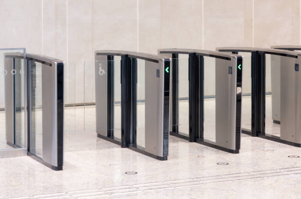 istock A row of turnstiles with a green arrow on them. 2153651736