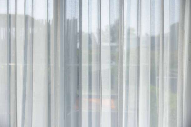 istock The white curtains are drawn, and the window is open, letting in a bright light 2153651784