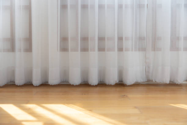 istock A white curtain hangs in front of a wooden floor 2153651788