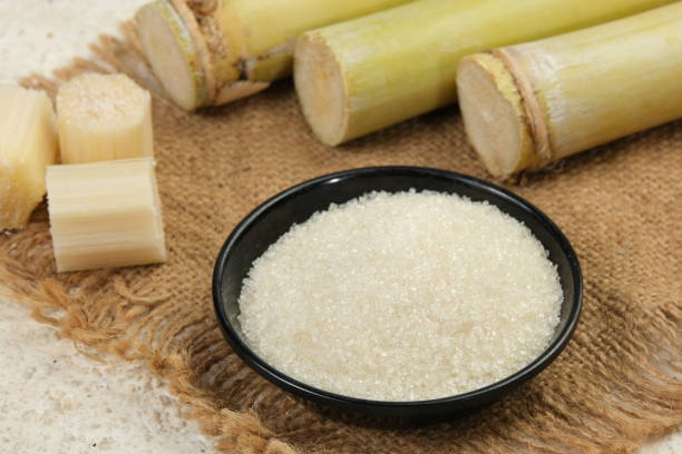 istock White Sugar With Fresh Sugar Cane on White Table 2153651872