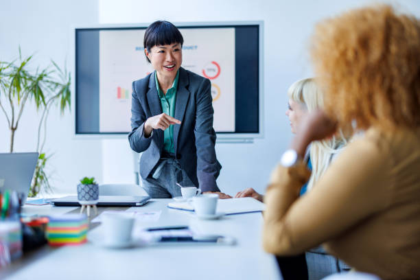 istock Businesswoman presenting in modern office 2153656612