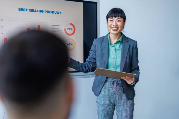 istock Smiling woman presenting business graph 2153656884
