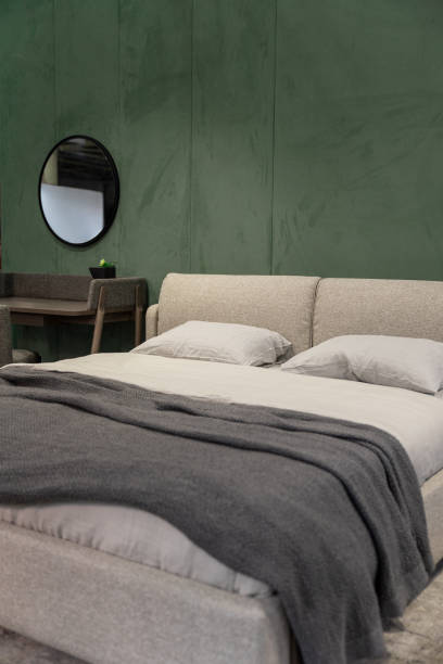 istock Fragment of bedroom with textile bedside table and fabric wall panels 2153656991