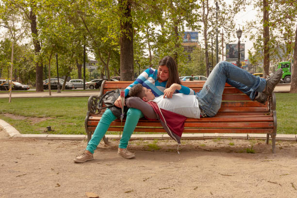 Santiago, Chile - May 14, 2017: A heterosexual chilean couple relaxing and enjoying an outdoor activity at Lastarria neighborhood in autumn season.
