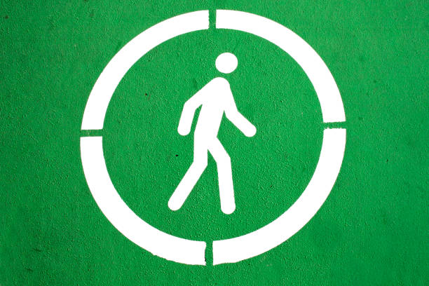 Ground markings for pedestrians on green background and white circle