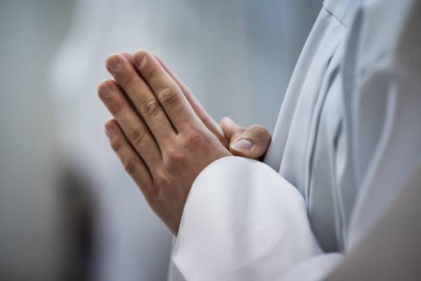 istock Hands of a priest during a mass in church. 2153659805