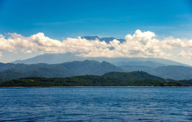 Seascape with water and mountain in the cloud