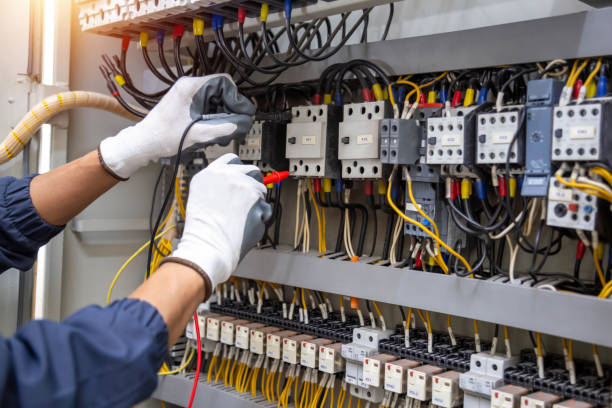 istock Electricity and electrical maintenance service, Engineer hand holding AC voltmeter checking electric current voltage at circuit breaker terminal and cable . 2153661172