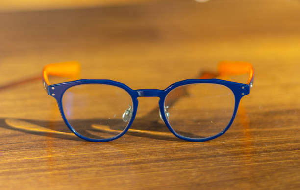 istock Blue frame glasses on a brown table in a Sydney Restaurant with colourful Bokeh Blurred Background NSW Australia 2153662441