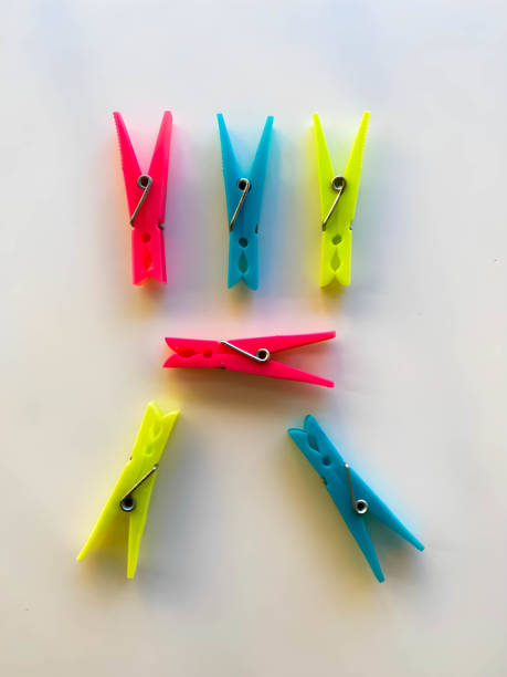 istock Plastic multicolored clothes pegs for hanging laundry outdoors. Beach Towel Clips,  Towel Holder, Plastic Clothes Pegs, Hanging Clip, Clamps, Clothes Pins. On white background 2153672147
