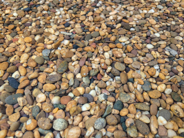 istock A bunch small colorful close up river rocks  texture background wallpaper. 2153672203