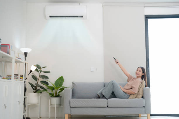 istock Young woman enjoying air conditioning at home 2153672677