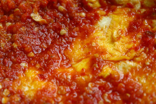 fried egg with red balado chili sauce close up