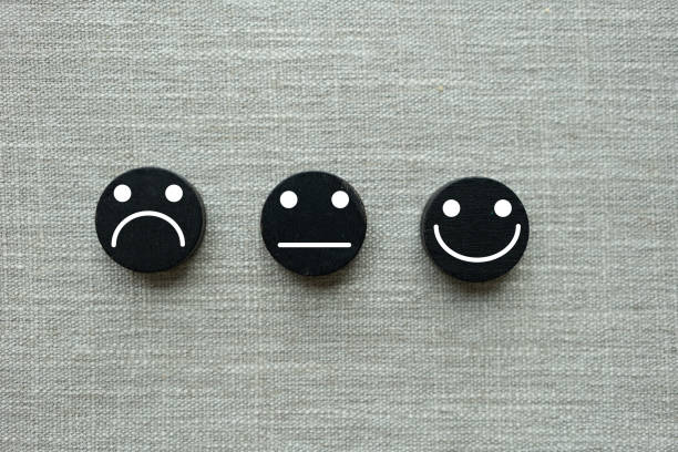 istock Happy, neutral and sad faces on black wooden blocks. Customer satisfaction or evaluation concept 2153675094