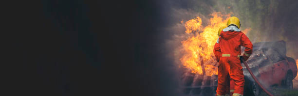 istock Firefighter fighting smoke flame use fire hose chemical water foam spray engine. Firefighter Rescue training in fire fighting extinguisher. Fireman wear hard hat safety suit uniform for protection 2153675851