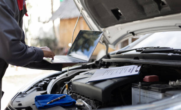 istock Services car engine machine, Automobile mechanic repairman checking a car engine with inspecting writing to the clipboard the checklist for repair machine, car service and maintenance. 2153679304