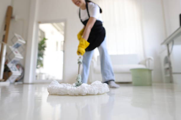 istock Cleaner is mopping floors at home with a mop. 2153679358