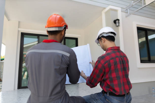 istock Contractor engineer discusses with an architect the construction of a home renovation project at the job site. 2153679519