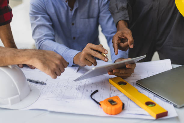 istock Contractor engineer discusses with an architect the construction of a home renovation project at the job site. 2153679562