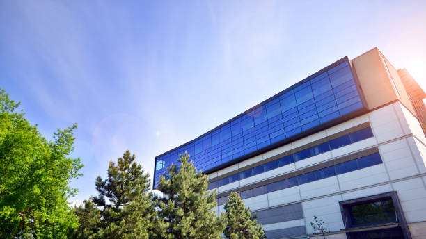 istock Sustainable glass office building with trees for reducing carbon dioxide. Eco-friendly building in modern city. 2153687613