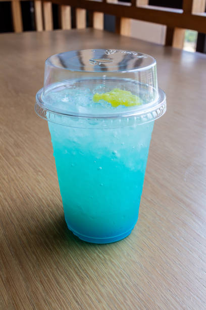 istock Refreshing Blue Drink with Yellow Fruit in Glass 2153688765