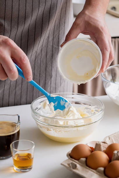 istock man wearing apron cooking tiramisu at kitchen 2153690028