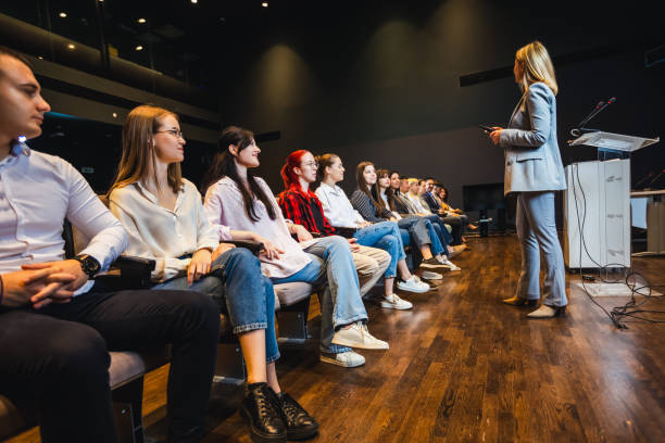 istock Female CEO having speech on press conference in convention center. 2153690471