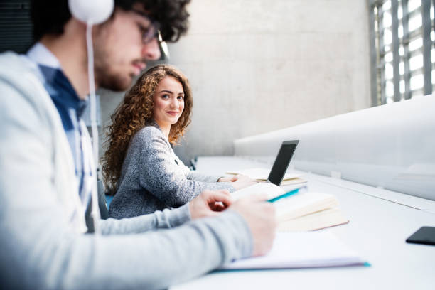 istock Young female student in library, focusing on final project, presentation. University student preparing for final exam. 2153692914