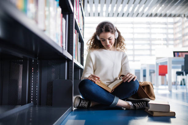 istock Young female student in library, focusing on final project, presentation. University student preparing for final exam. 2153692972