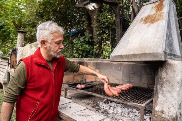 istock Mature man preparing a barbecue in the yard 2153693195