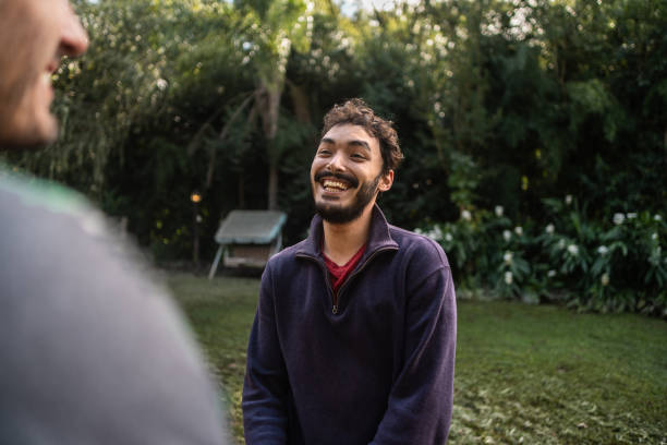 Young man talking with friend outdoors