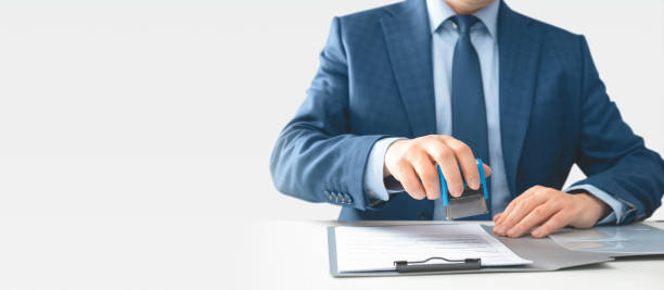 istock Businessman hand stamping on document at desk 2153700077
