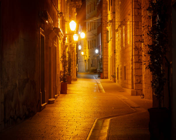 istock Quiet Mediterranean Street at Night with Warm Lantern Glow 2153700635