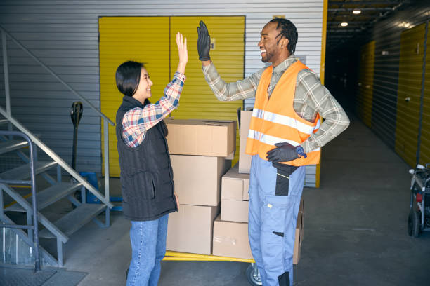 istock Team of storehouse coworkers greeting one another before cargo unloading 2153700827
