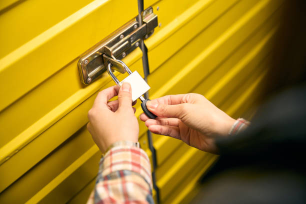 istock Tenant is padlocking steel self-storage unit door 2153700886