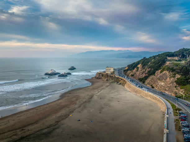 Aerial view of Ocean Beach and Cliff House building at sunset.