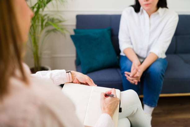 istock Closeup of a female psychologist leading a therapy session and taking some notes while listening to a patient 2153705490