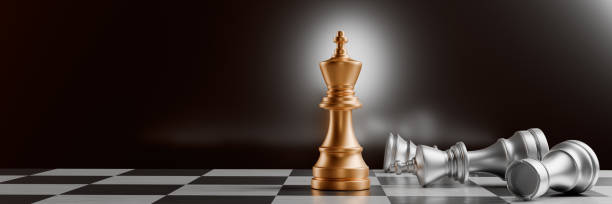 istock A golden chess piece stands victorious among fallen silver pieces on a chessboard.3d rendering 2153707613