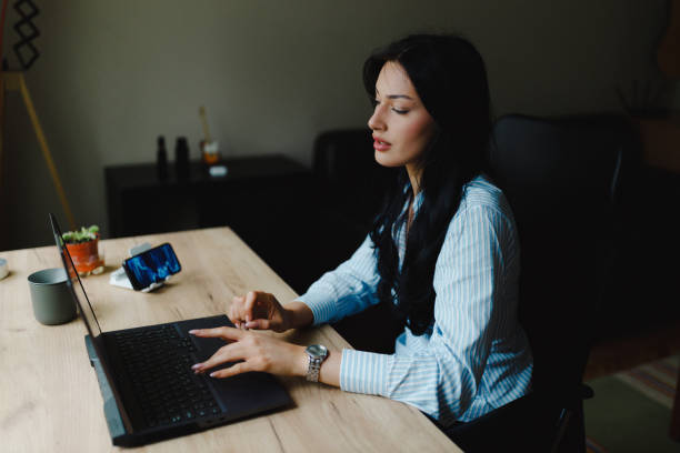 istock Young woman using a laptop and working from home 2153707884