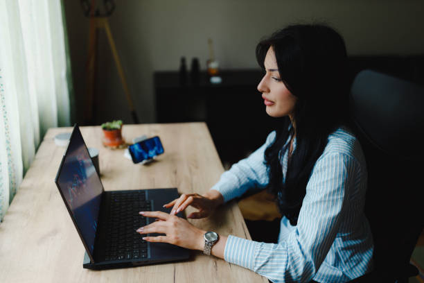 istock A young businesswoman using a laptop and working from home 2153707936