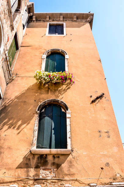 istock A tall building with three windows and a balcony 2153708691