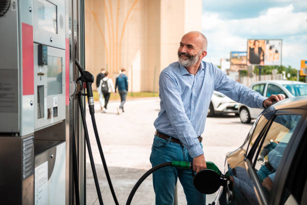 istock Senior Man Refueling Vehicle at Service Station 2153708904