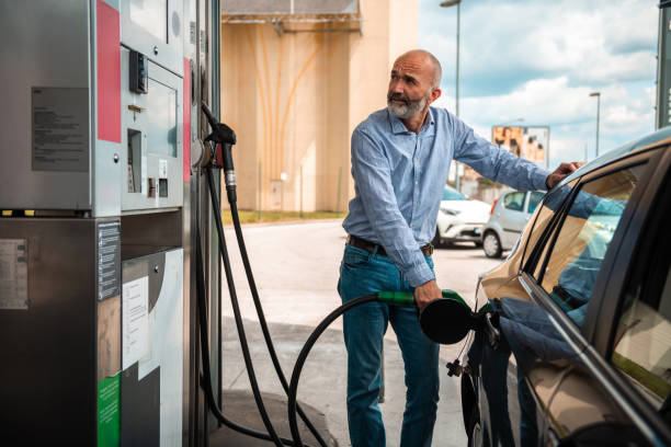 istock Mature Man Refueling Automobile at Gas Pump 2153708907