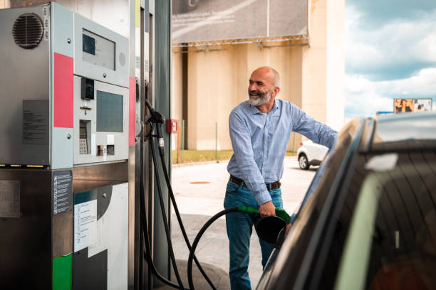 istock Mature Man Refueling Vehicle at Service Station 2153708916