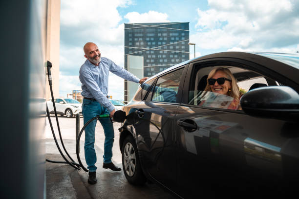 Swiss and traveler people fill oil to tank of car in petrol station at Villages of Tschlin and Ramosch near Samnaun on September 2, 2017 in Graubunden, Switzerland